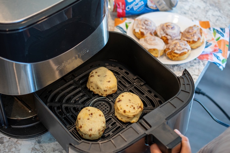 Cinnamon rolls on a plate and in an open air fryer