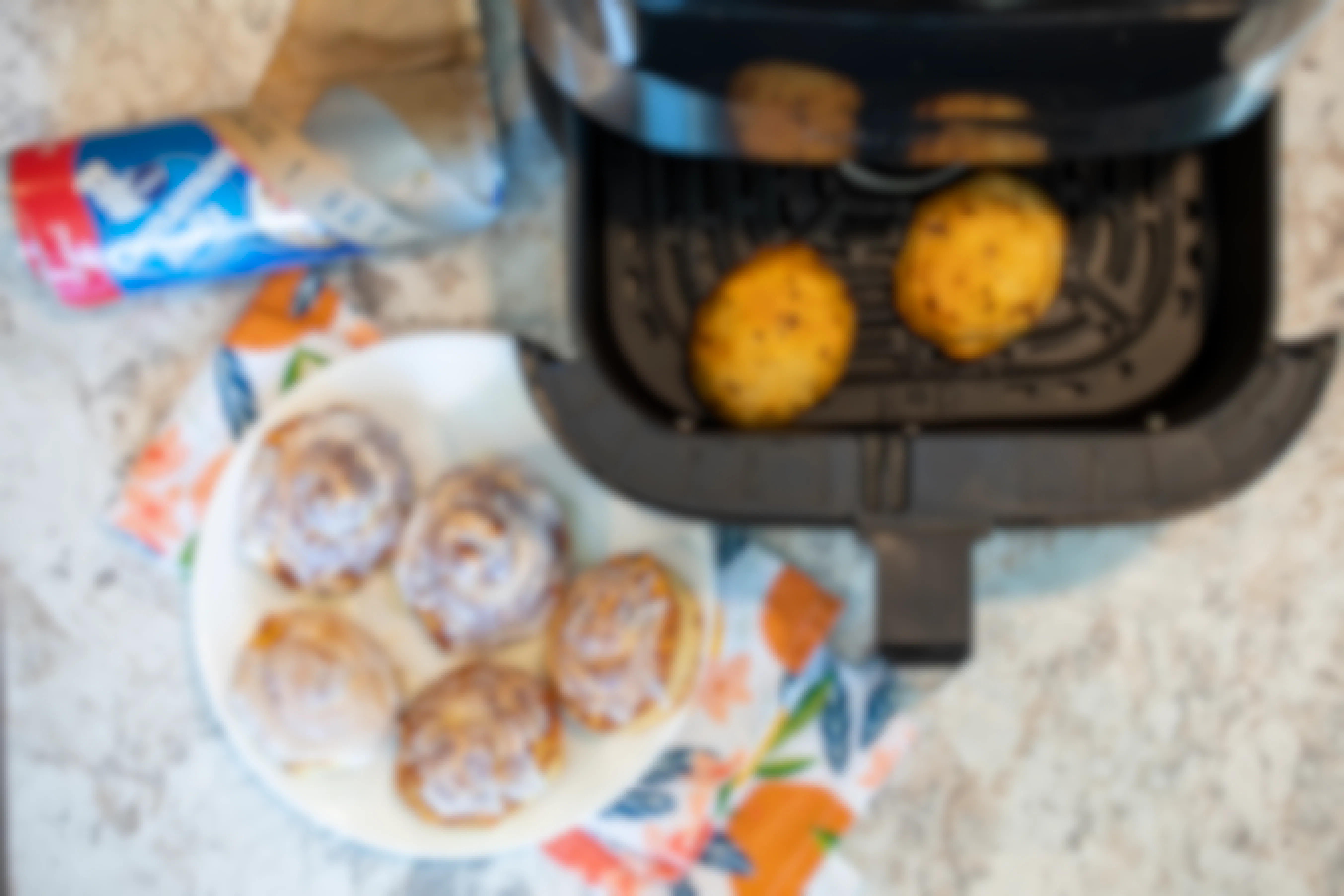 Cinnamon rolls on a plate and in an open air fryer