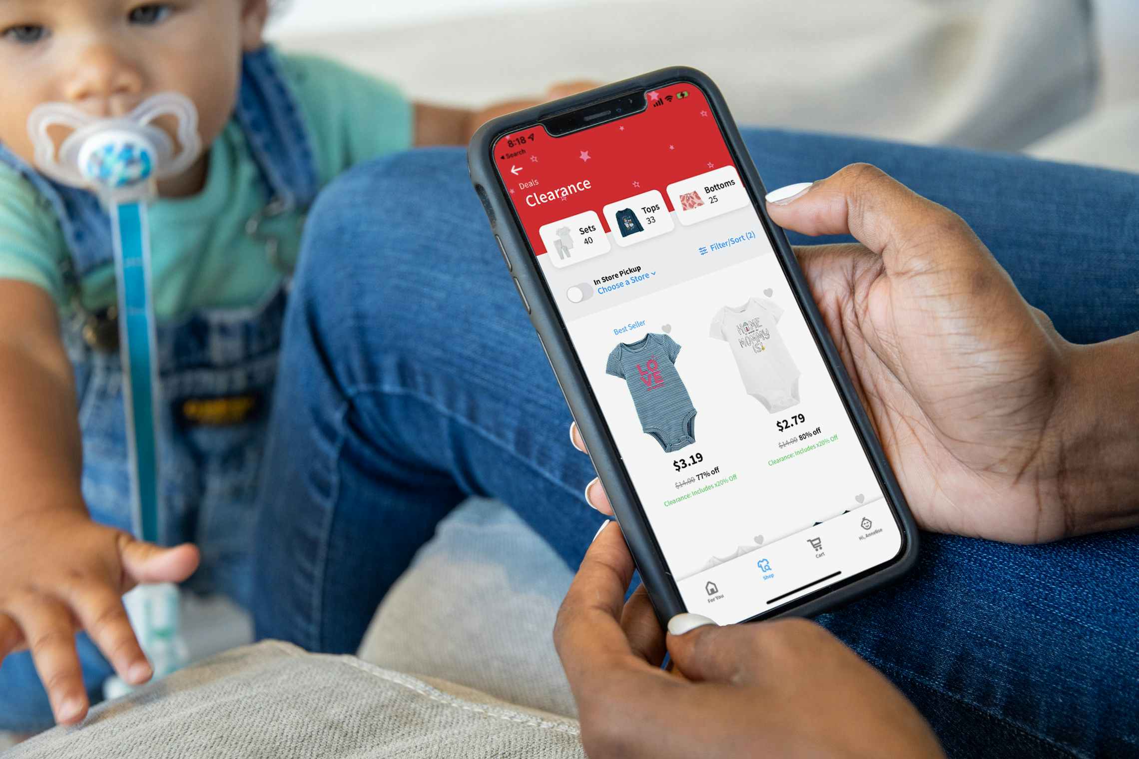 A woman browsing clearance kids clothing on the Carters app.