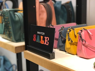 winter sale tabletop sign inside a coach store in December