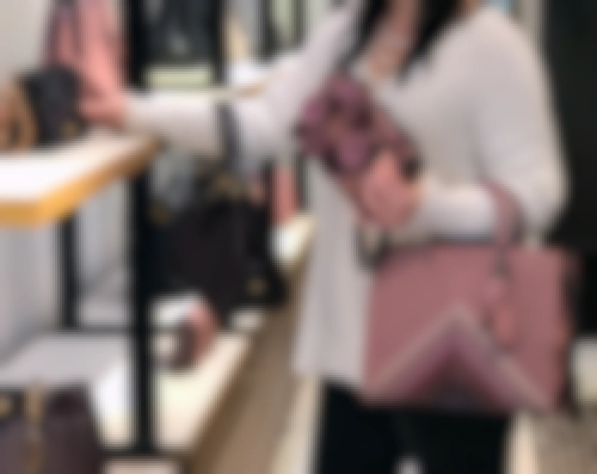 woman shopping for a variety of authentic coach bags inside a coach store
