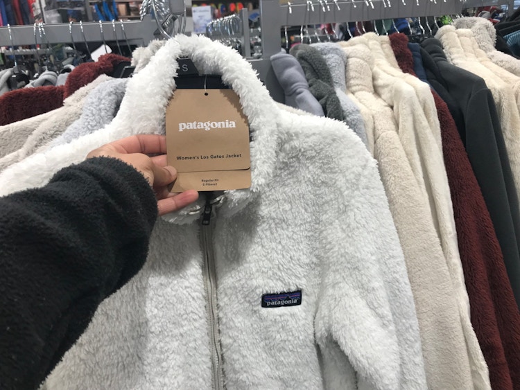 someone holding price tag on patagonia jacket