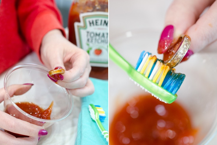 Woman picking up a ring with ketchup on it, then scrubbing it with a toothbrush
