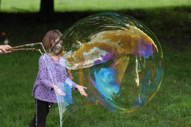 Make giant bubbles with sticks, a washer and string.