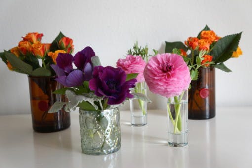 Reuse a candle jar as a flower vase.