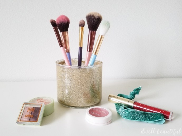 Store makeup brushes in old candle jars.