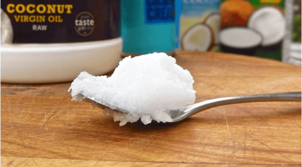 Swallow coconut oil to ease the pain of a sore throat or cough.