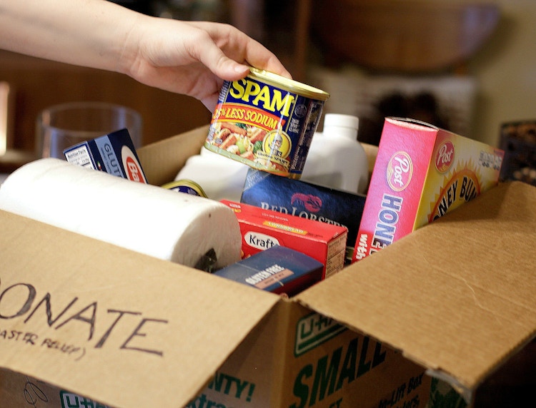 a person putting food into a donate box