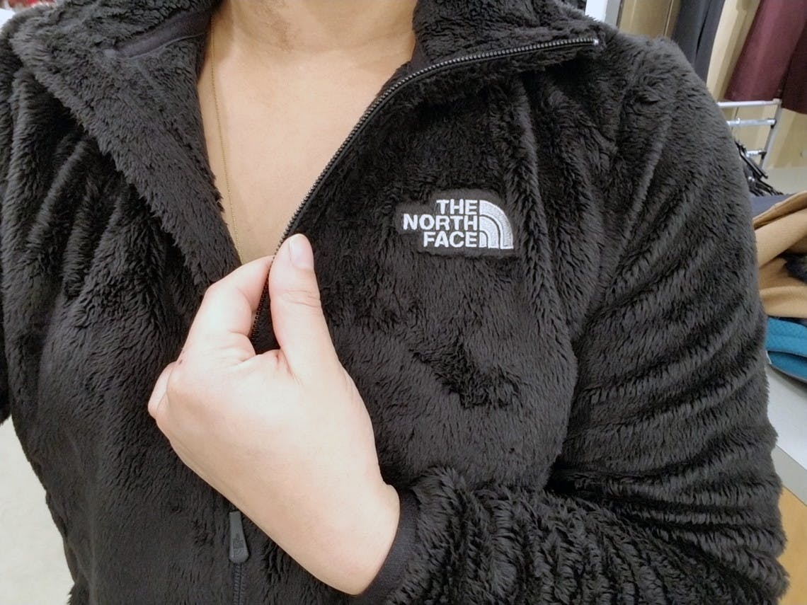 A woman wearing a The North Face fleece zip jacket.