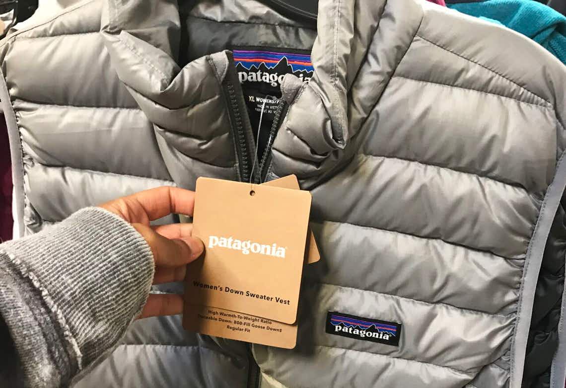 someone holding price tag on patagonia vest