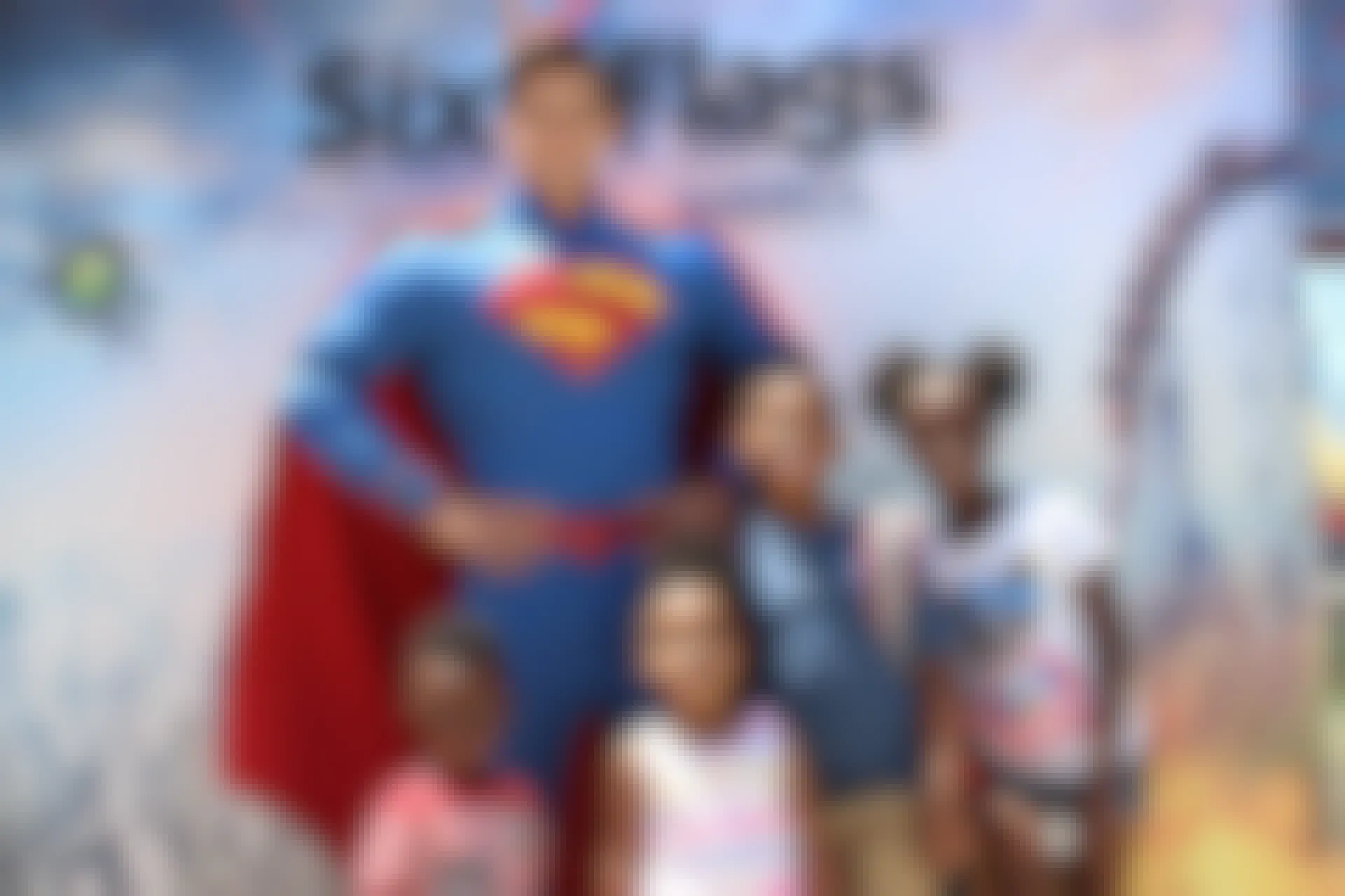 For children posing for a photo with a man dressed as superman at six flags America amusement park