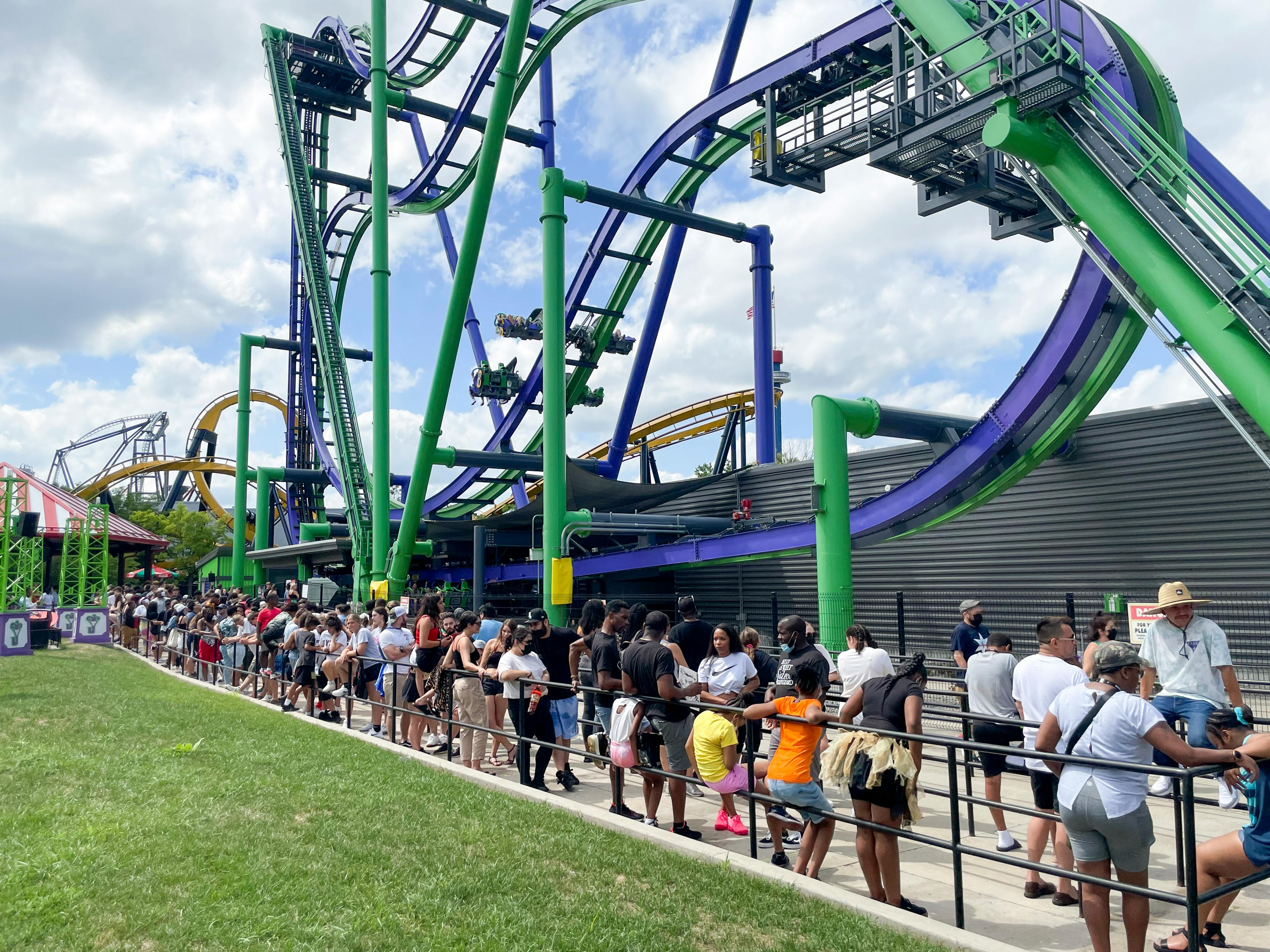 A line of people waiting to ride a roller coaster