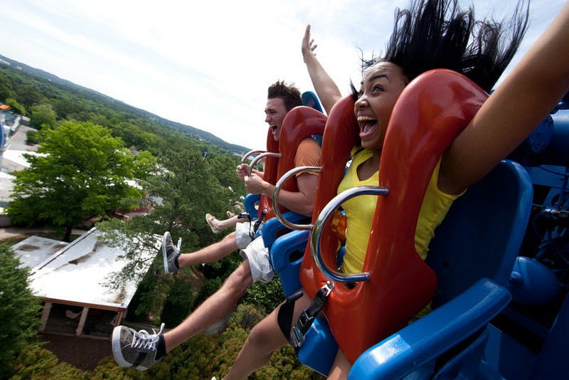 People scream in joy on a Six Flags roller coaster