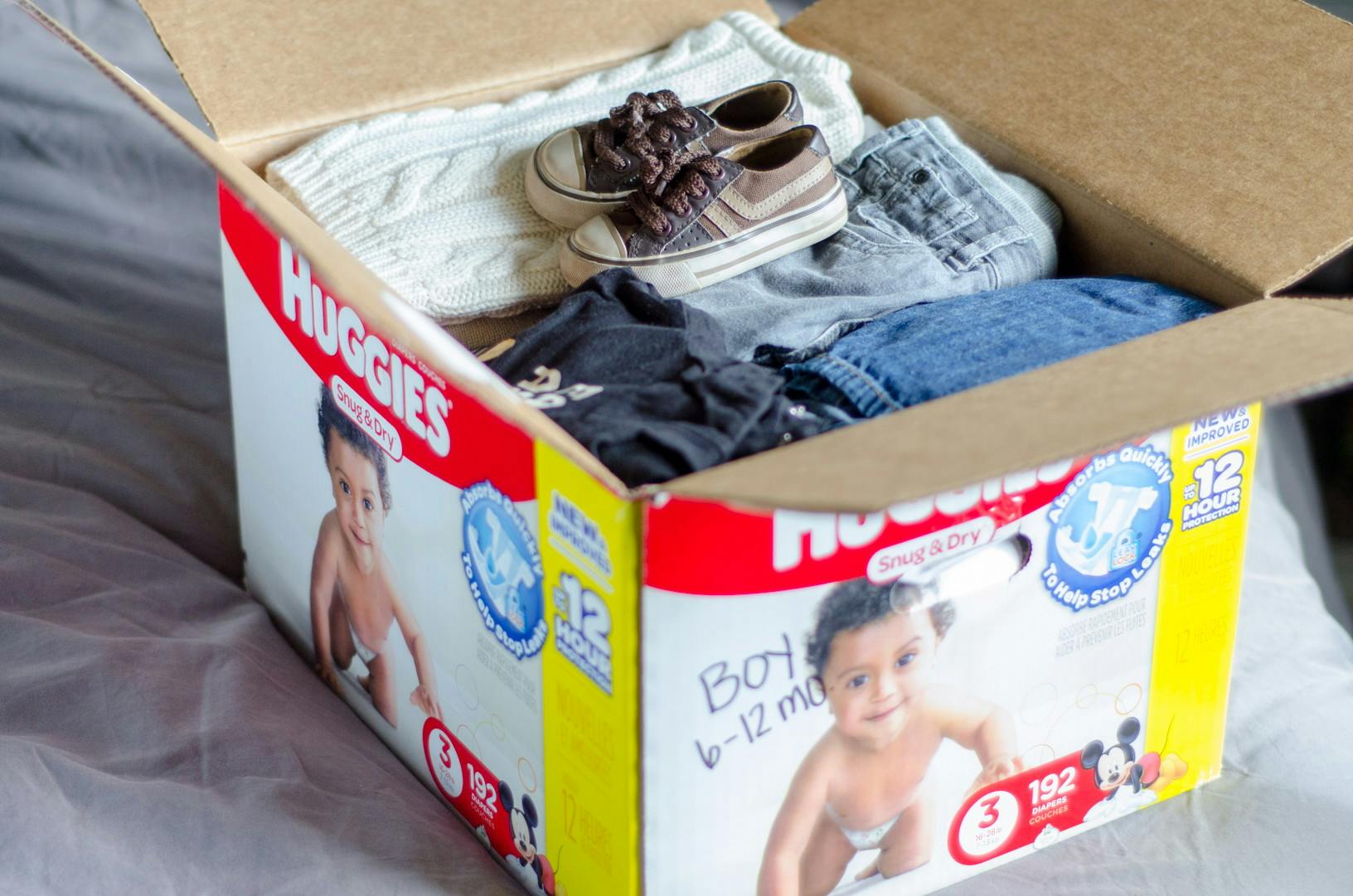 huggies diaper box with baby clothes in it