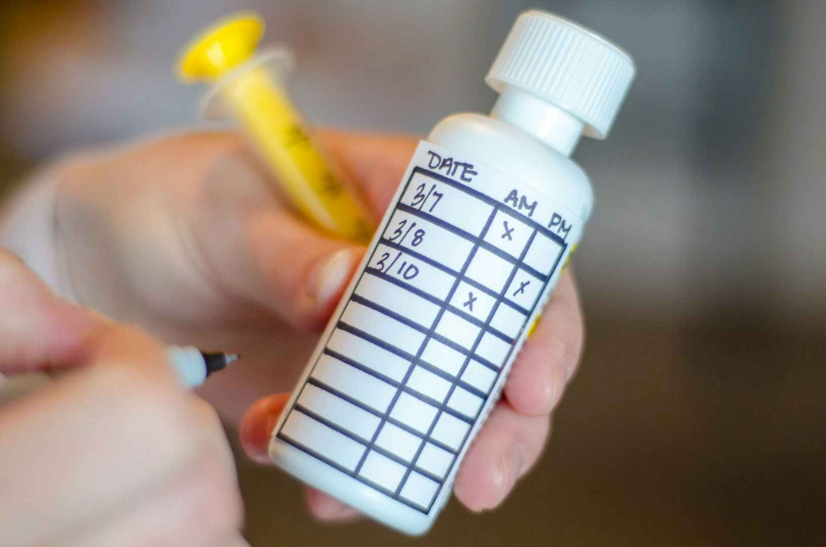 liquid pain reliever bottle with tracking chart