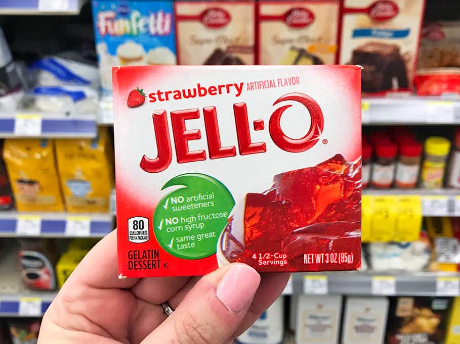 person holding strawberry jell-o box in store