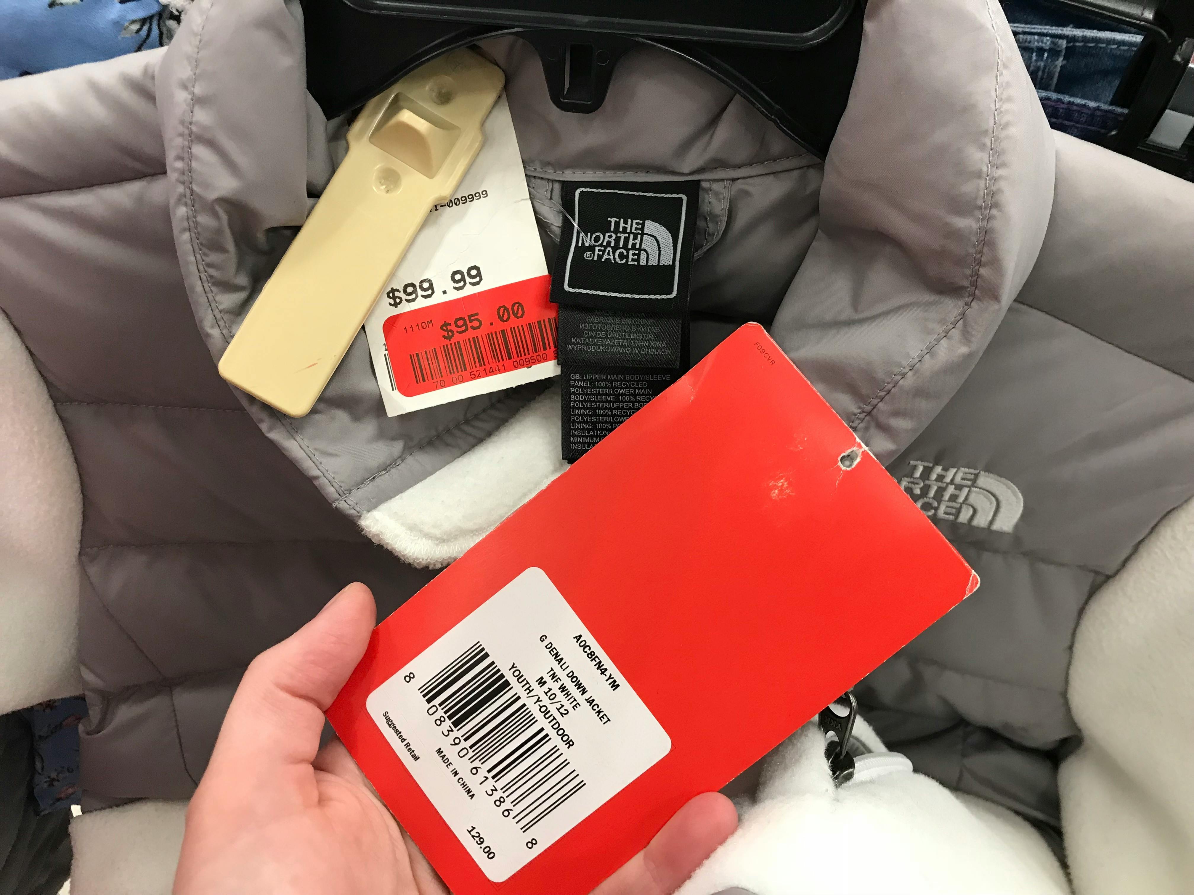 sale tags on a north face fleece jacket at tj maxx