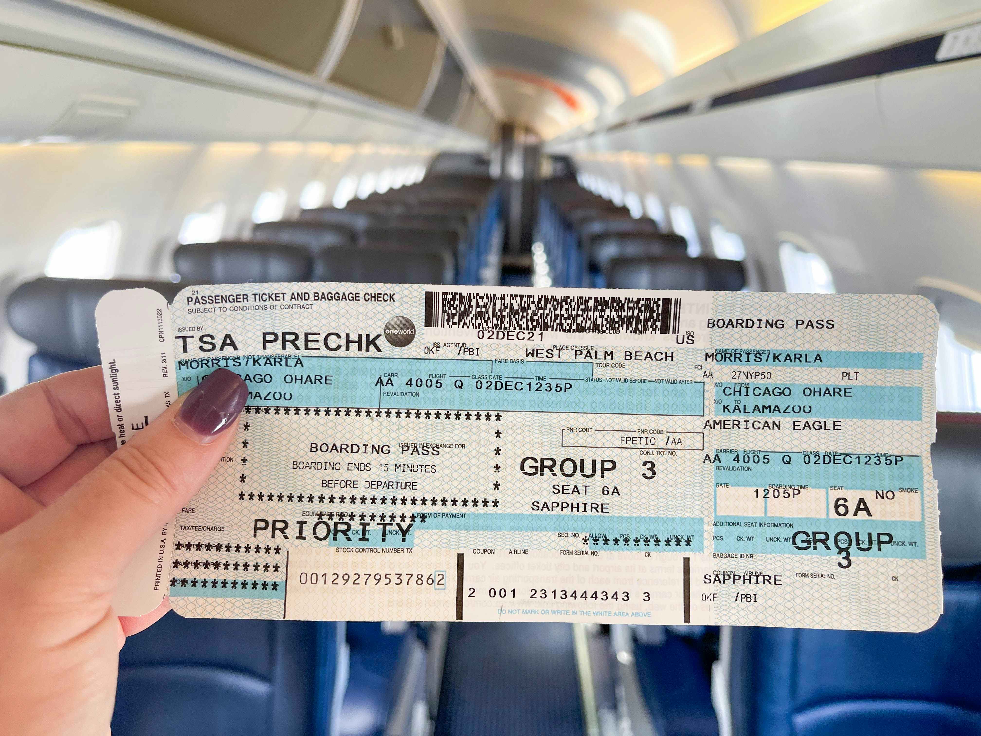 woman holding airplane ticket on empty airplane.