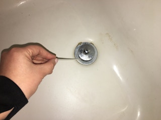 Cut slits in a zip tie to make a drain snake to unclog hair.