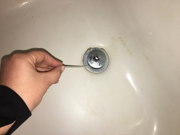 Cut slits in a zip tie to make a drain snake to unclog hair.