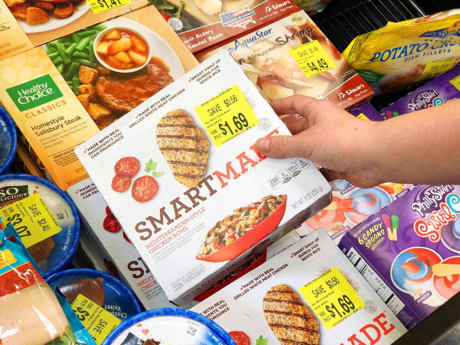 person grabbing smartmade frozen meal on clearance from freezer section