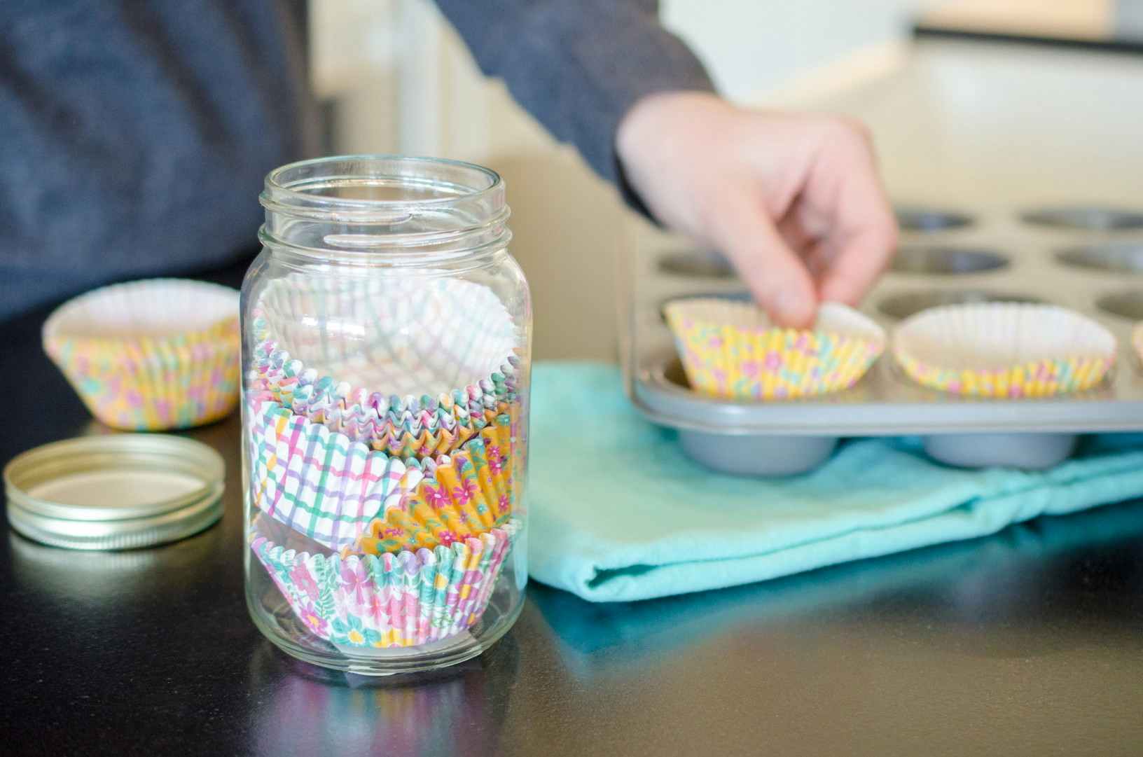 A person prevent muffin cups from getting crushed by storing them in a canning jar