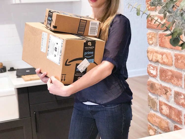 Someone carrying amazon boxes