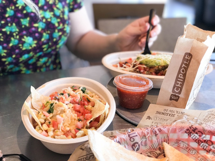 someone eating a chipotle burrito bowl