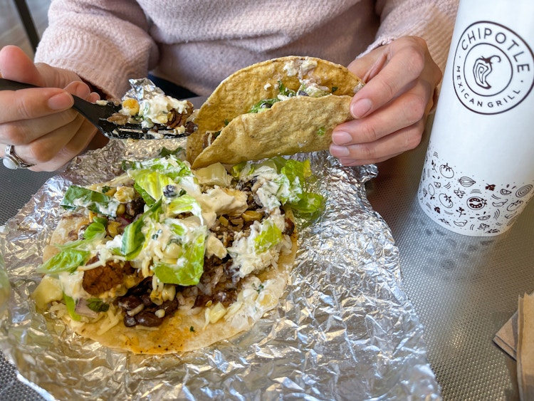 someone filling a taco