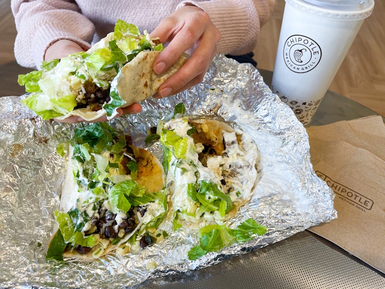 someone picking up a taco