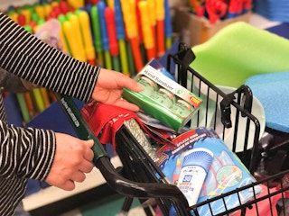 someone putting hand sanitizer in cart