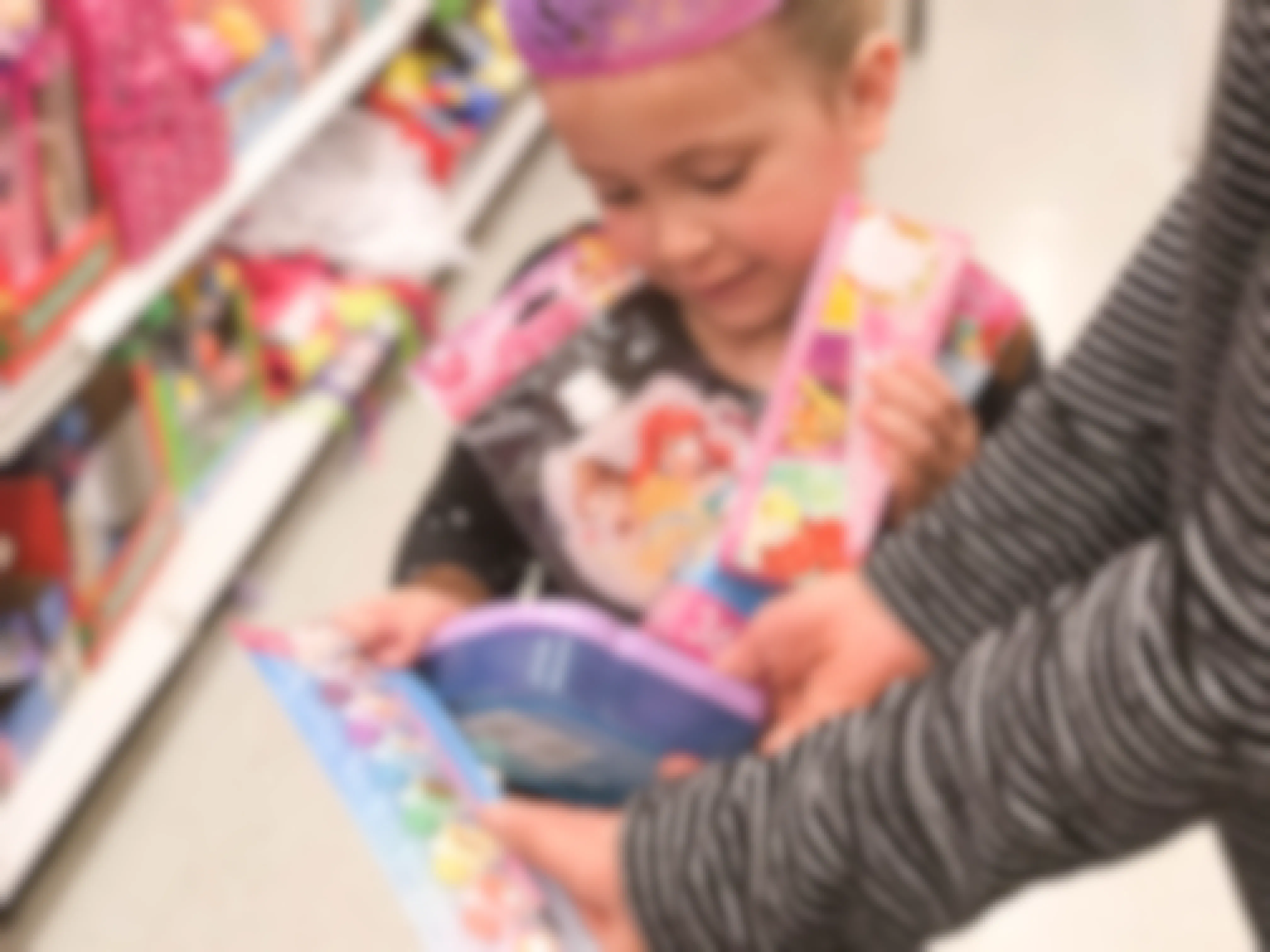girl holding disney princess toys