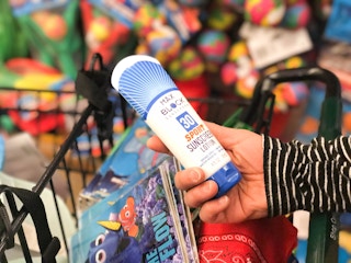 someone holding sunscreen