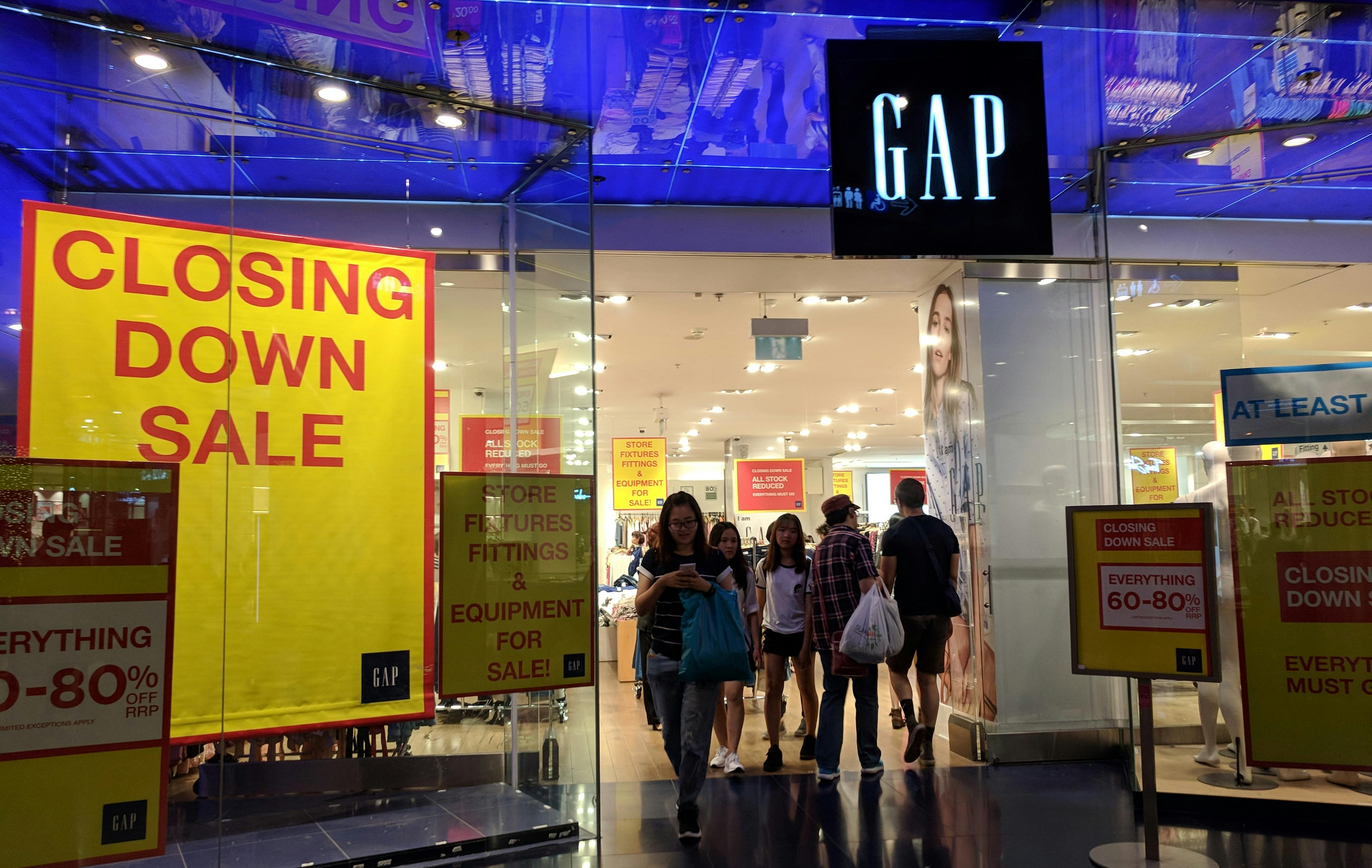 Gap store with "Closing Down Sale" signs in the window.
