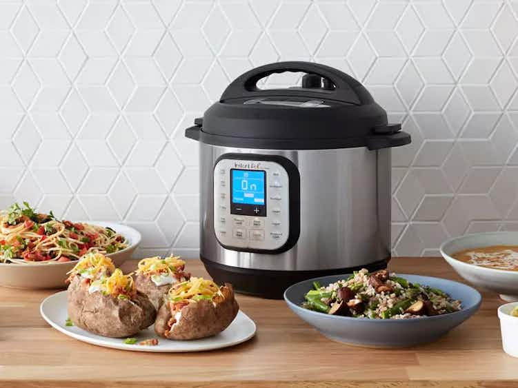 instant pot on kitchen counter with various dishes