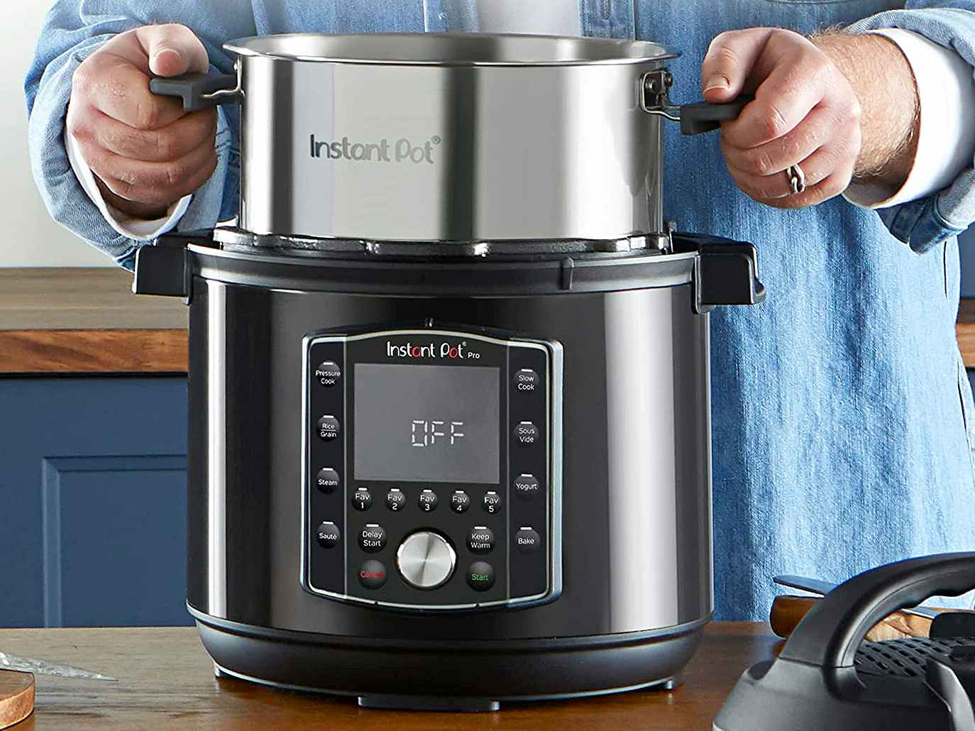 person lifting insert from instant pot in kitchen