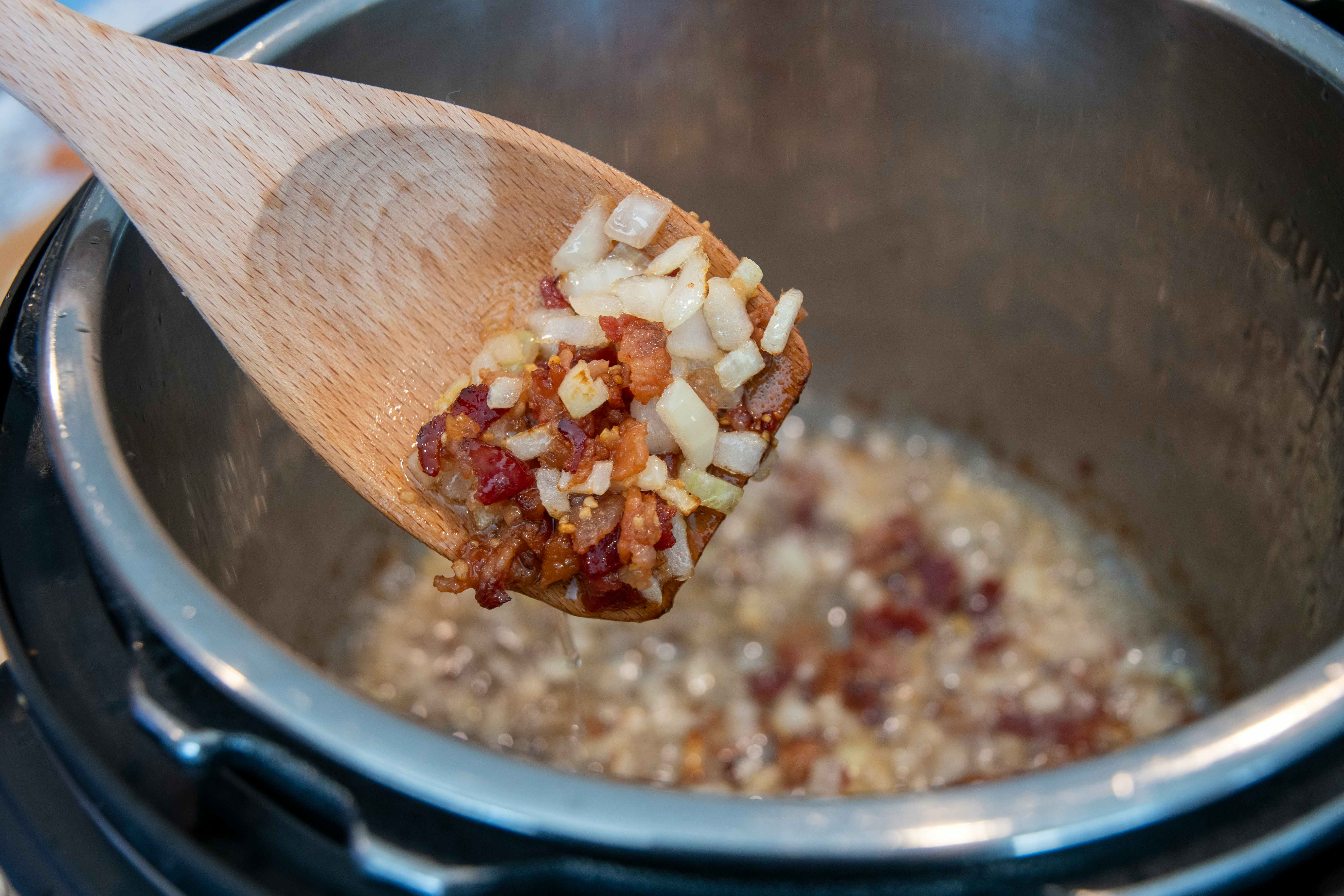Bacon and onions being sautéed in an instant pot