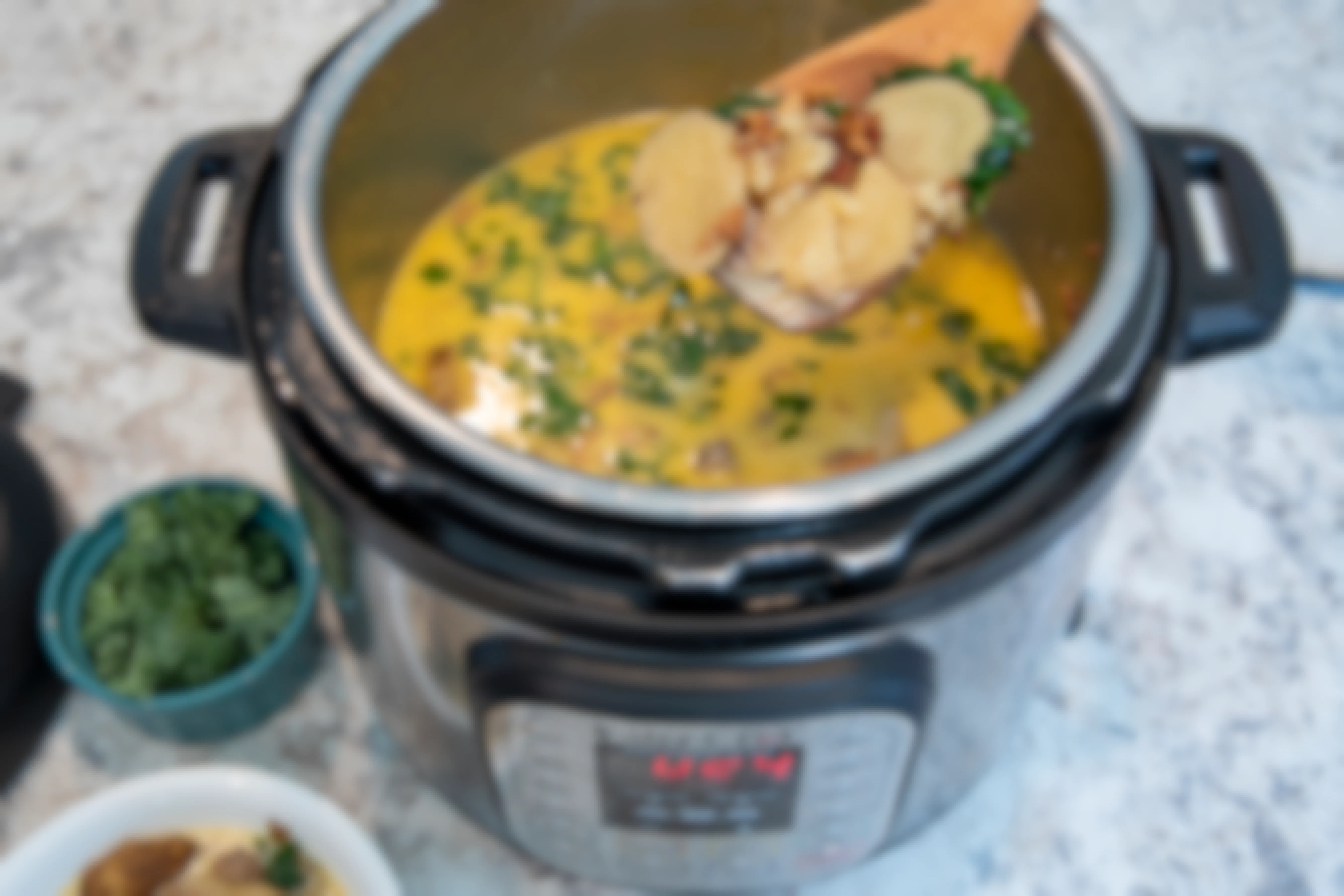 A person ladling soup out of an instant pot