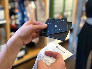 A person holding a Lululemon gift card