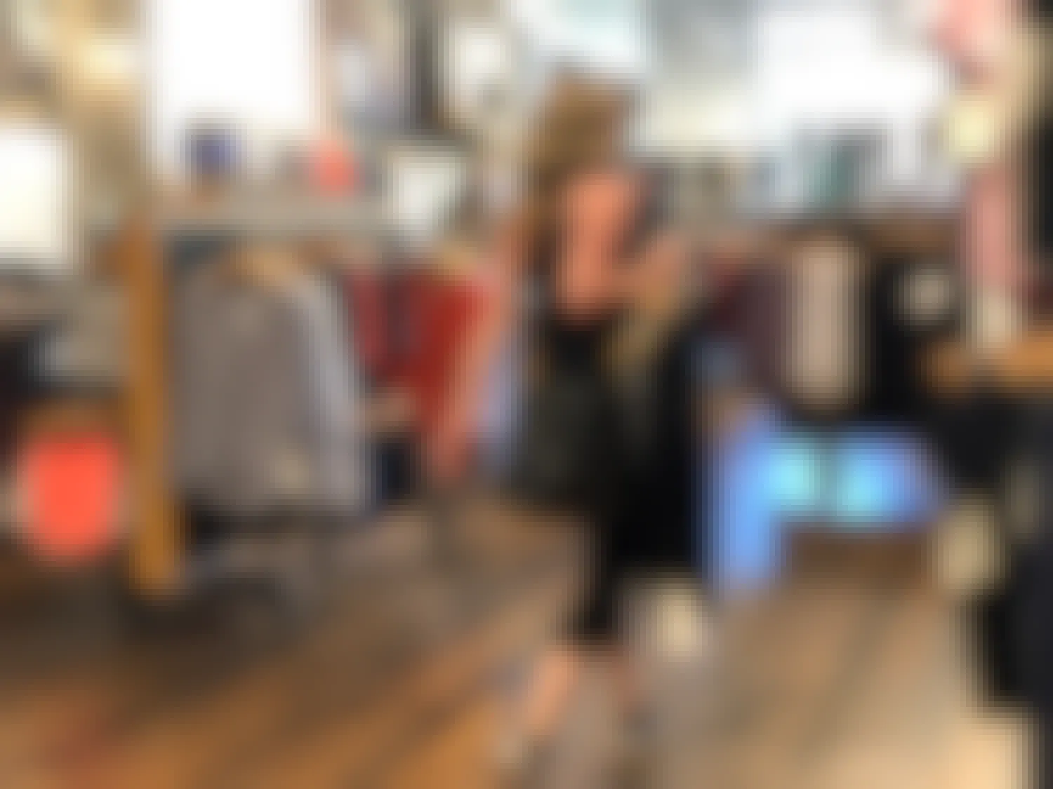 A woman walking through a Lululemon store with some clothing in her hand.