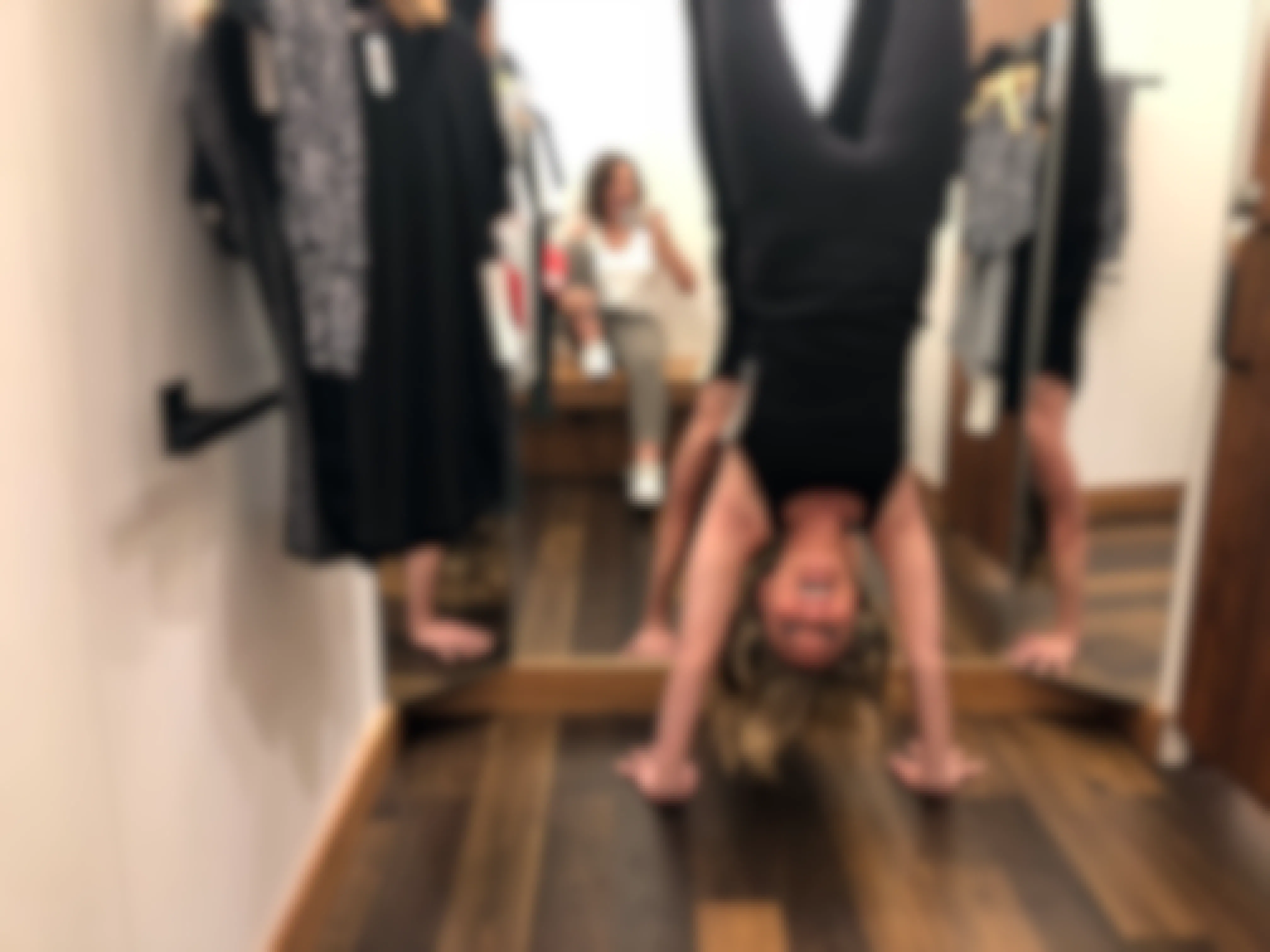 Woman doing a headstand inside the Lululemon fitting room