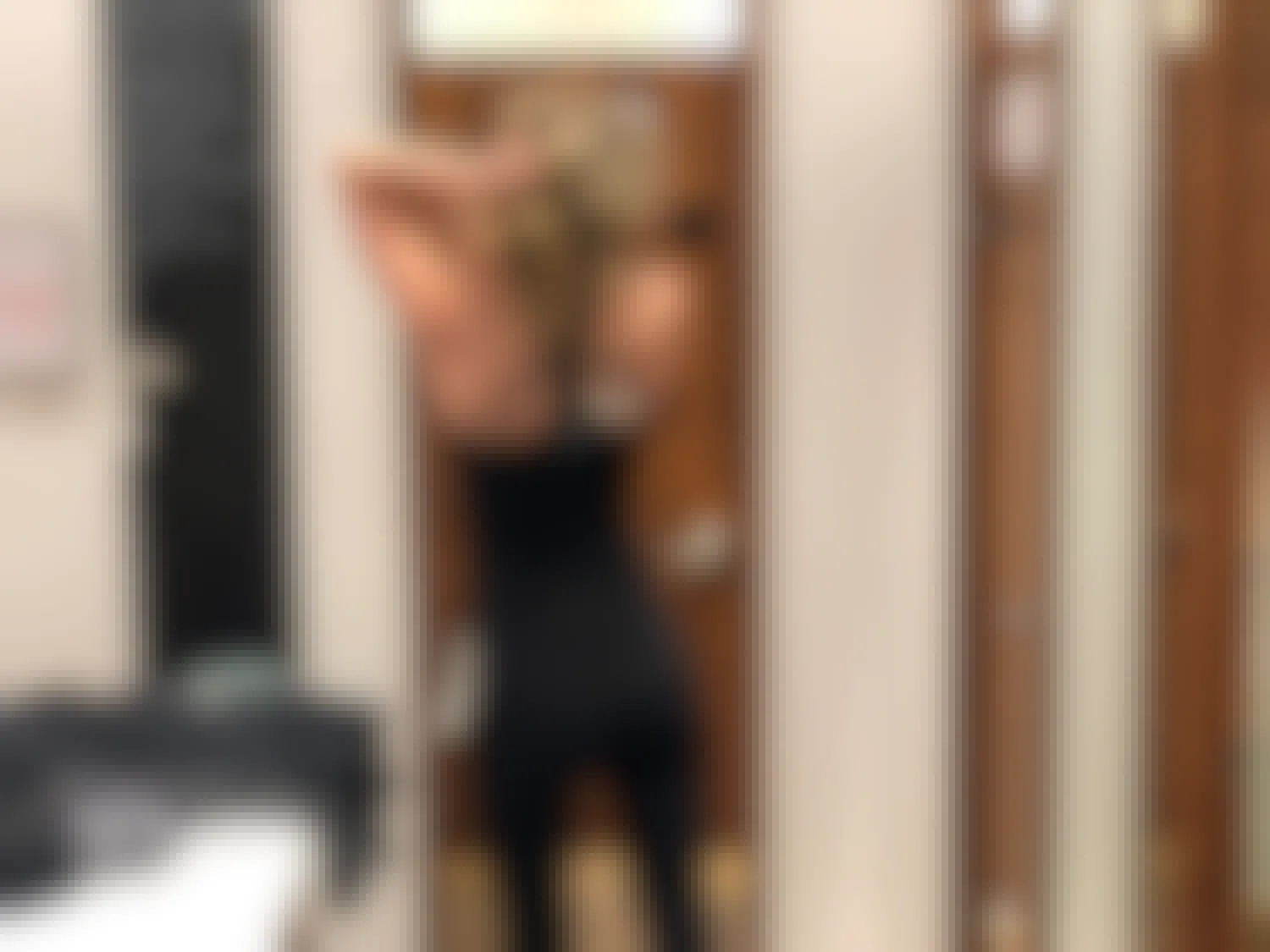 A woman trying on clothing inside a Lululemon store.