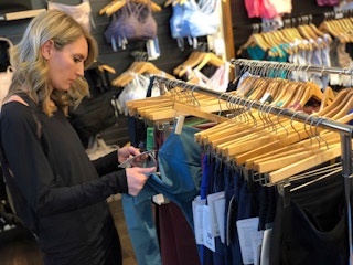 A woman shopping for active wear at a Lululemon store