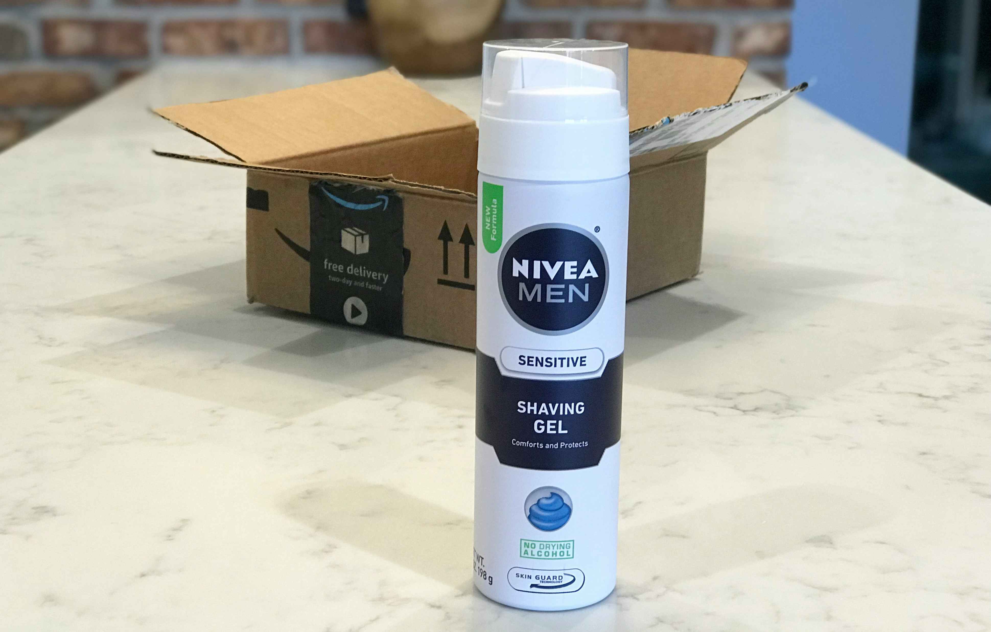 A bottle of Nivea Men shave gel in front of an open box.