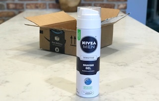 A bottle of Nivea Men shave gel in front of an open box.