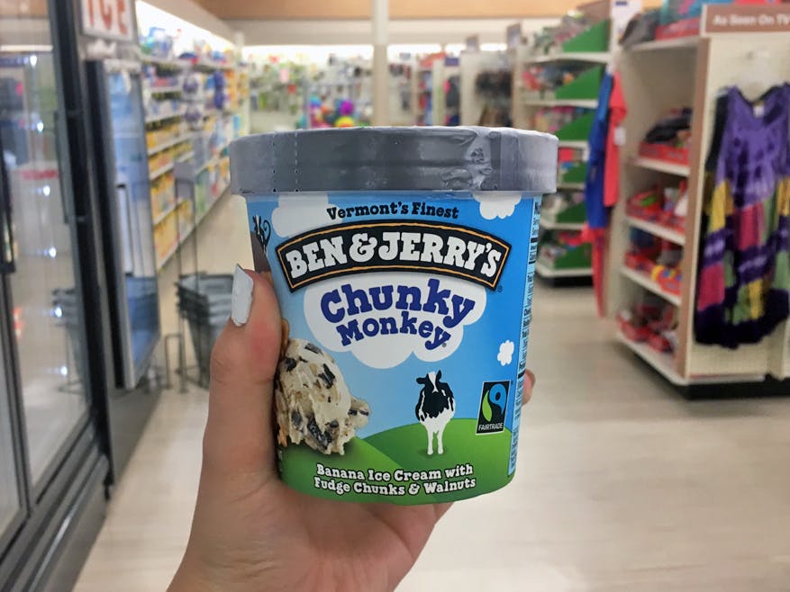 Someone holding a pint of Ben & Jerry's ice cream in a store