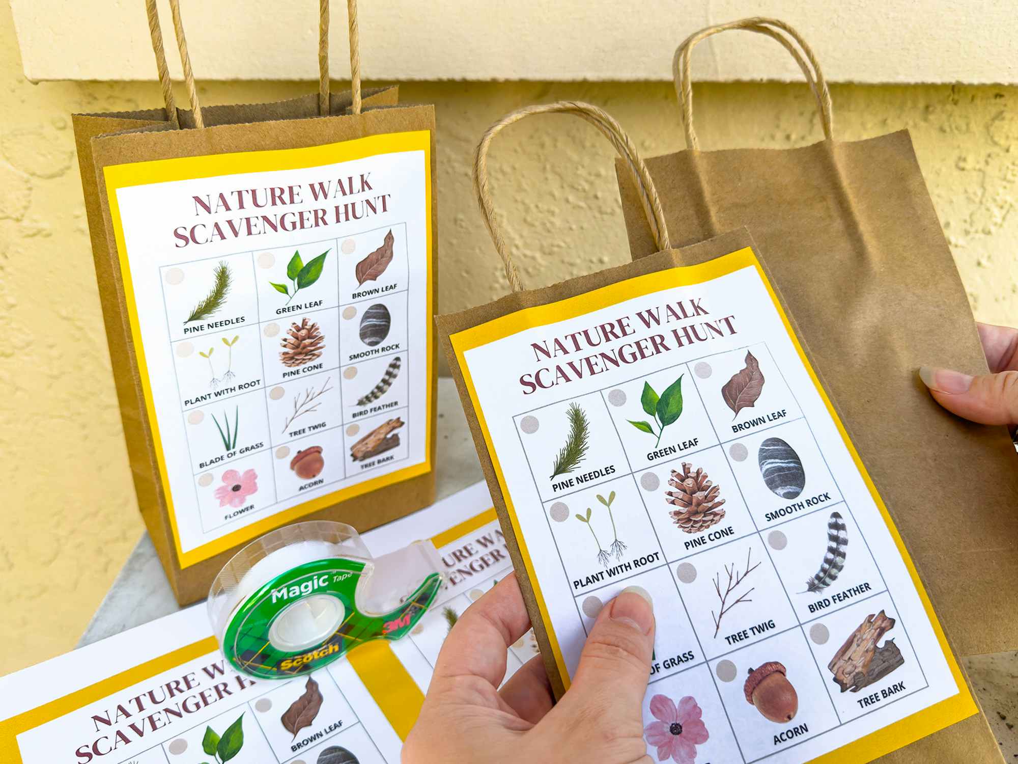 Someone putting together some nature walk scavenger hunt bags for a kids activity