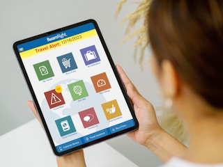 person looking at roam right travel insurance app on ipad