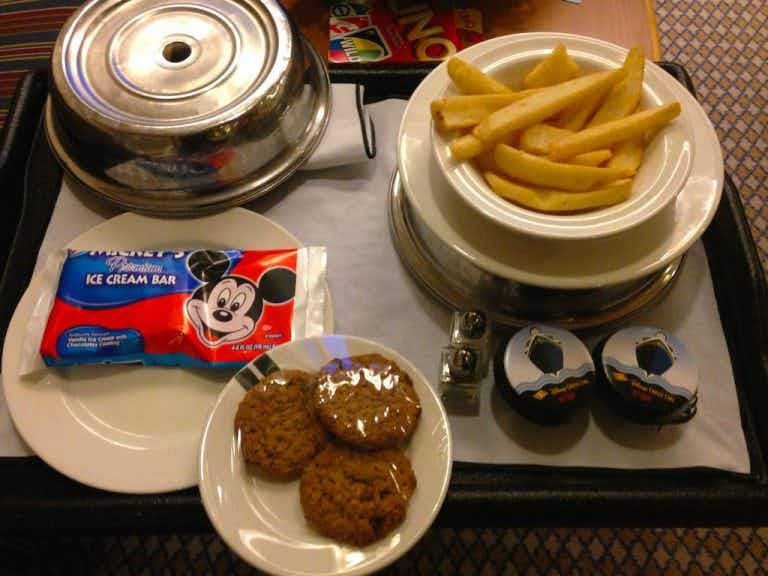 a plate of food with mickey themed dessert for a disney cruise