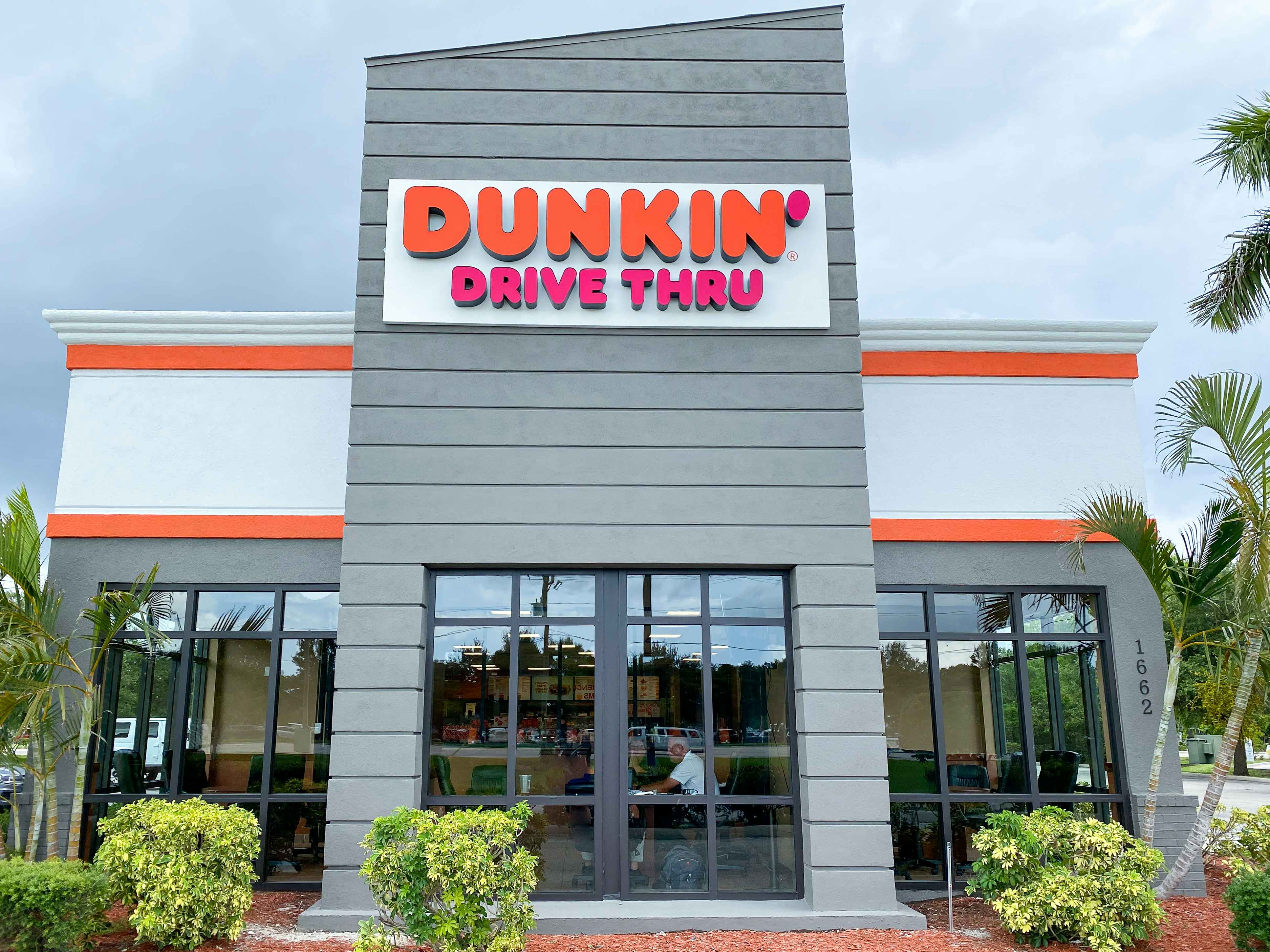 A Dunkin storefront during the day time in Florida.